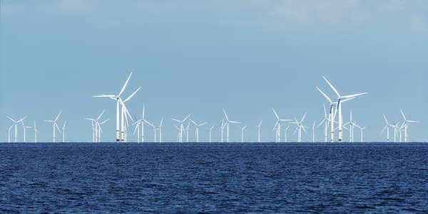 sea with windmills in background